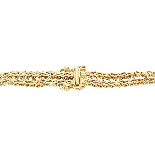 Pulsera de dos hilos eslabón boleado con aplicaciones en oro tres tonos 18 kilates.