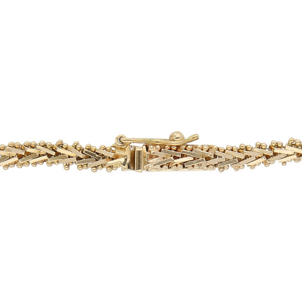 Pulsera eslabón boleado con colgantes en oro tres tonos 14 kilates.