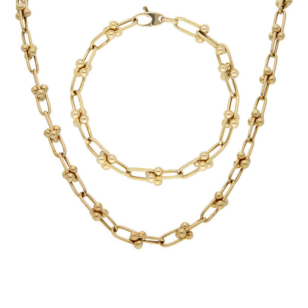 Juego de gargantilla y pulsera eslabón cruzado con aplicaciones en oro amarillo 14 kilates.