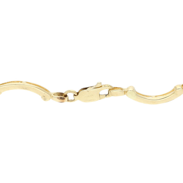 Pulsera eslabón articulado con aplicación y sintéticos en oro amarillo 14 kilates.