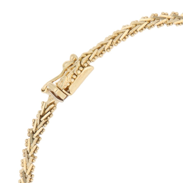 Pulsera eslabón boleado con aplicaciones en oro tres tonos 14 kilates.