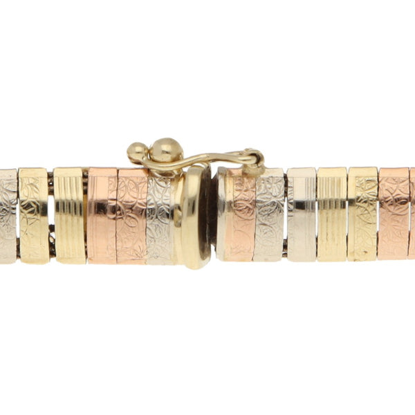 Pulsera eslabón articulado en oro tres tonos 14 kilates.