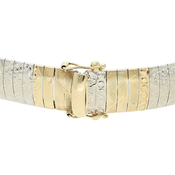 Pulsera eslabón laminado en oro dos tonos 14 kilates.