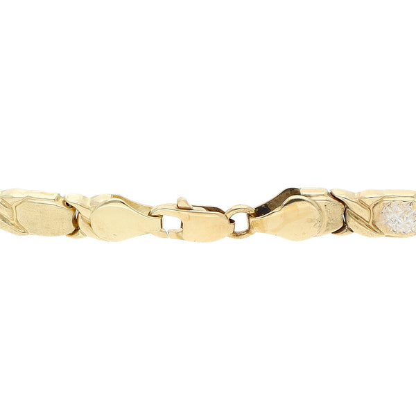 Pulsera eslabón articulado platinado en oro amarillo 14 kilates.