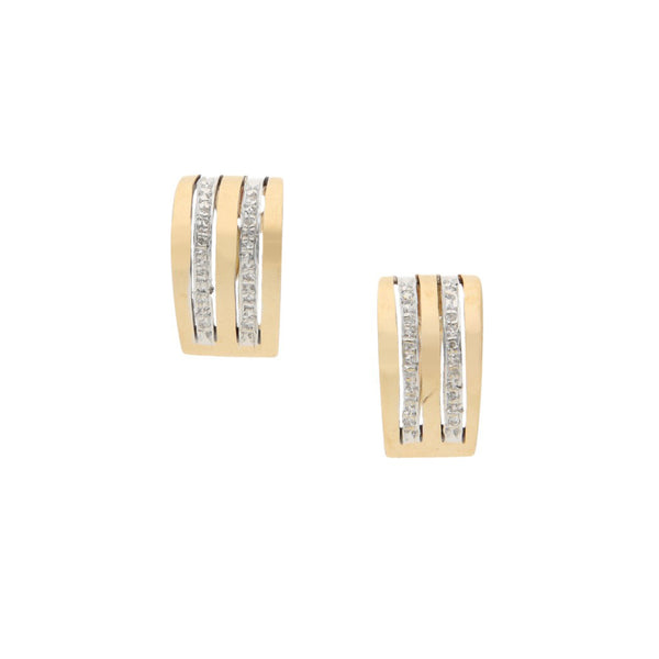 Aretes estilizados con diamantes en oro dos tonos 14 kilates.