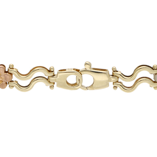 Pulsera eslabón articulado motivo flores en oro tres tonos 14 kilates.