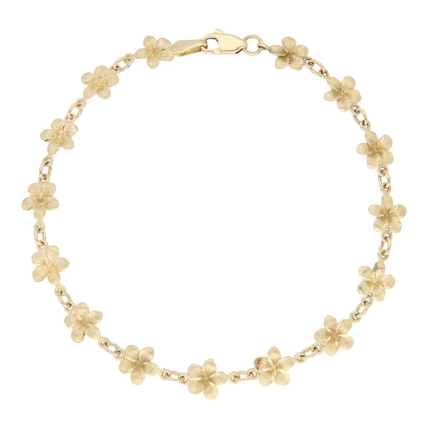 Pulsera eslabón cruzado con aplicaciones motivo flor en oro amarillo 14 kilates.