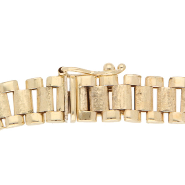 Pulsera eslabón articulado con aplicaciones motivo felinos y circonias en oro amarillo 14 kilates.