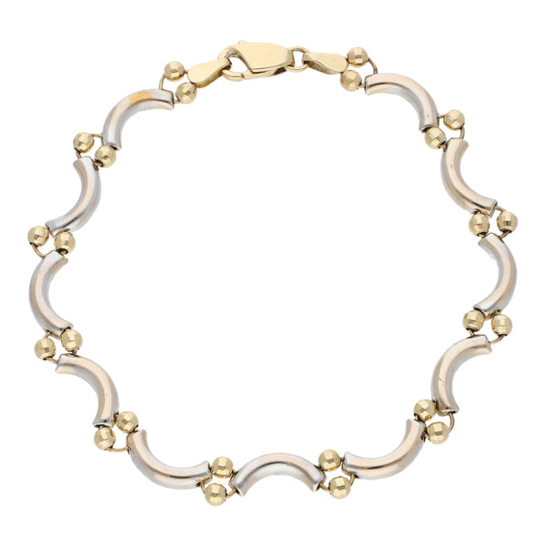 Pulsera eslabón combinado con aplicación motivo esferas en oro dos tonos 14 kilates.