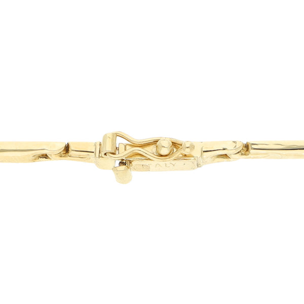 Pulsera eslabón articulado con aplicación de sintéticos en oro amarillo 18 kilates.
