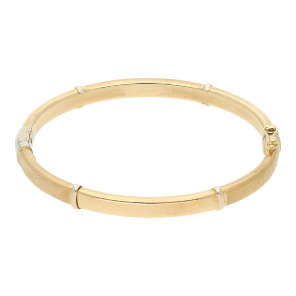 Pulsera de arillo articulada con aplicaciones en oro dos tonos 18 kilates.