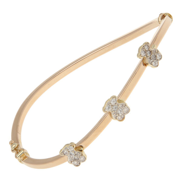 Pulsera de arillo articulada con aplicaciones motivo osos y circonias en oro dos tonos 14 kilates.
