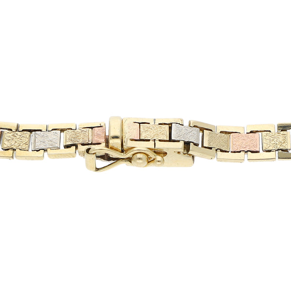Pulsera eslabón articulado en oro tres tonos 14 kilates.