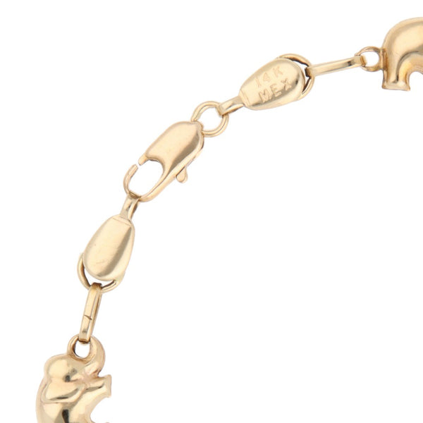 Pulsera eslabón cruzado con aplicaciones motivo elefantes en oro amarillo 14 kilates.