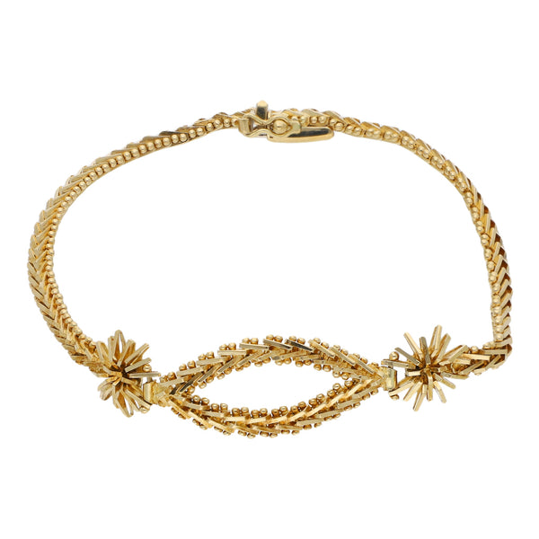 Pulsera eslabón boleado con aplicaciones en oro amarillo 18 kilates.