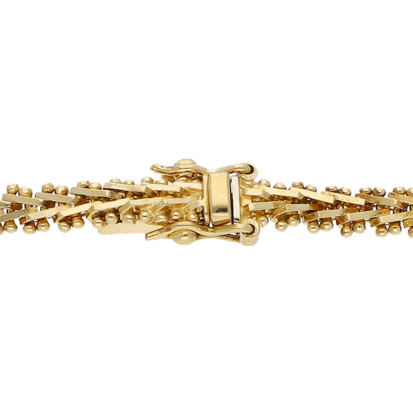 Pulsera eslabón boleado con aplicaciones en oro amarillo 18 kilates.