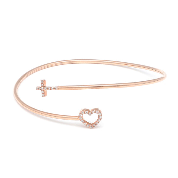 Pulsera de arillo abierta motivo cruz y corazón con diamantes en oro rosa 14 kilates.