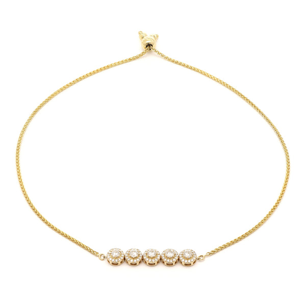 Pulsera eslabón tejido con aplicaciones y diamantes en oro amarillo 14 kilates.