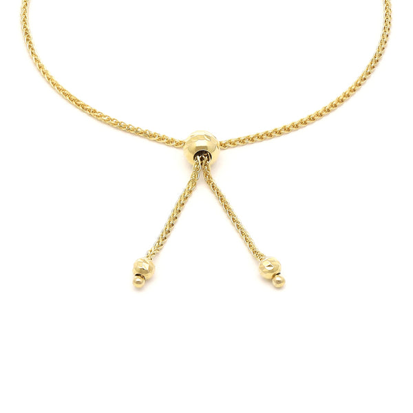 Pulsera eslabón tejido con aplicaciones y diamantes en oro amarillo 14 kilates.
