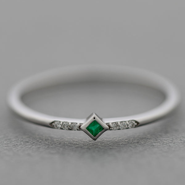 Anillo diseño especial con diamantes y esmeralda en oro blanco 14 kilates.