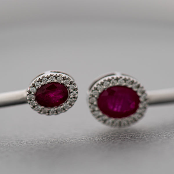 Pulsera de arillo abierta con aplicaciones de diamantes y rubíes en oro blanco 14 kilates.