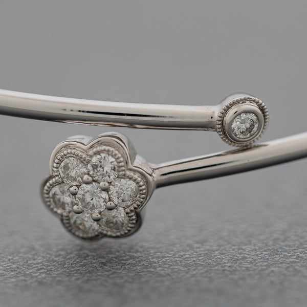 Pulsera de arillo abierta motivo flor con diamantes en oro blanco 14 kilates.