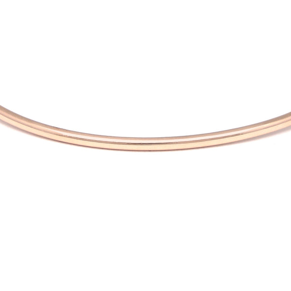 Pulsera de arillo abierta con diamantes y rubíes en oro rosa 14 kilates.
