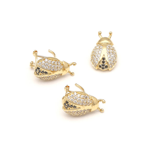 Juego de dije y aretes diseño especial con sintéticos motivo catarina en oro amarillo 14 kilates.
