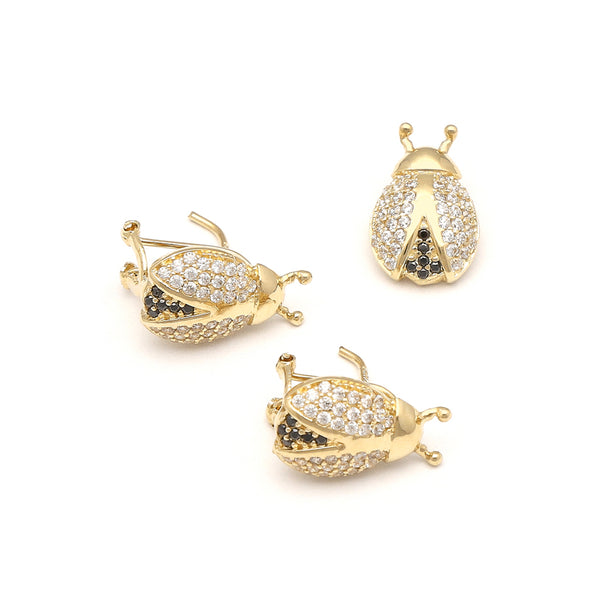Juego de aretes y dije diseño especial motivo catarina con sintéticos en oro amarillo 14 kilates.