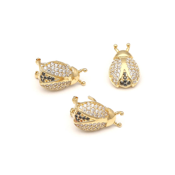 Juego de aretes y dije diseño especial con sintéticos motivo catarina en oro amarillo 14 kilates.
