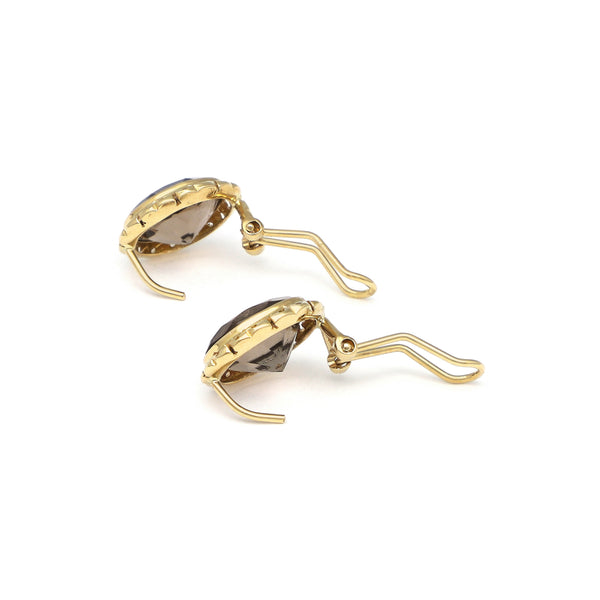 Juego de anillo y aretes calados con topacio en oro amarillo 14 kilates.