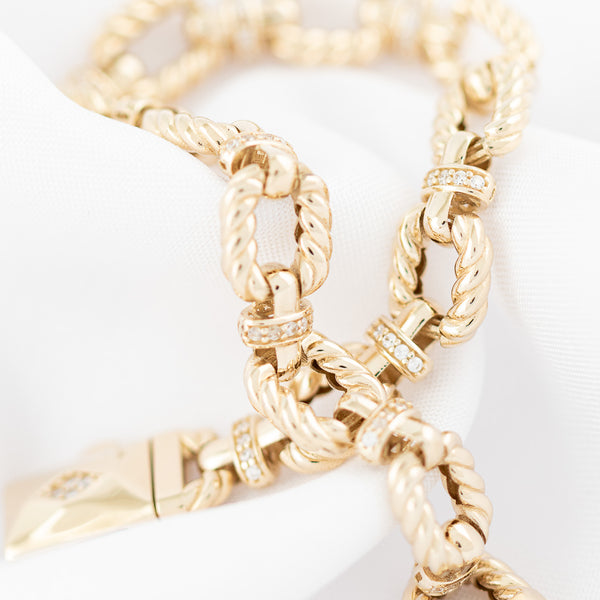 Pulsera eslabón combinado con circonias en oro amarillo 14 kilates.