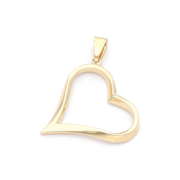 Dije facetado motivo corazón en oro amarillo 14 kilates.
