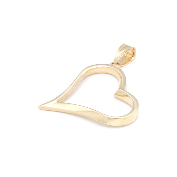 Dije facetado motivo corazón en oro amarillo 14 kilates.