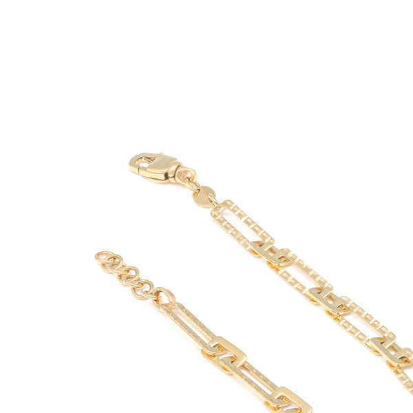 Pulsera eslabón cruzado en oro amarillo 14 kilates.