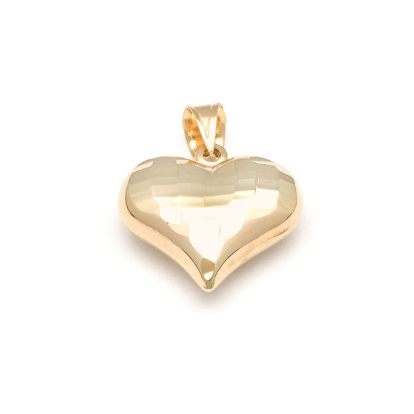 Dije hueco motivo corazón en oro amarillo 14 kilates.