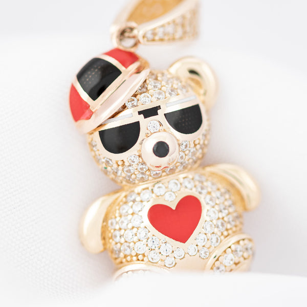 Dije hueco motivo oso con circonias y esmalte en oro amarillo 14 kilates.