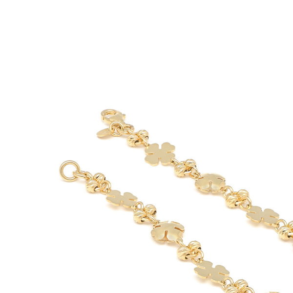 Pulsera eslabón combinado motivo tréboles en oro amarillo 14 kilates.
