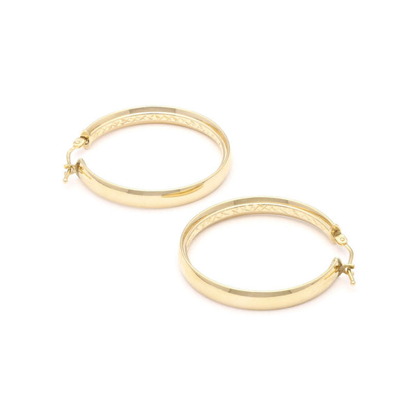 Arracadas lisas en oro amarillo 14 kilates.