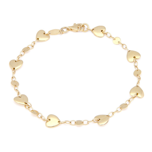 Pulsera eslabón cruzado con aplicaciones motivo corazón y círculos en oro amarillo 14 kilates.