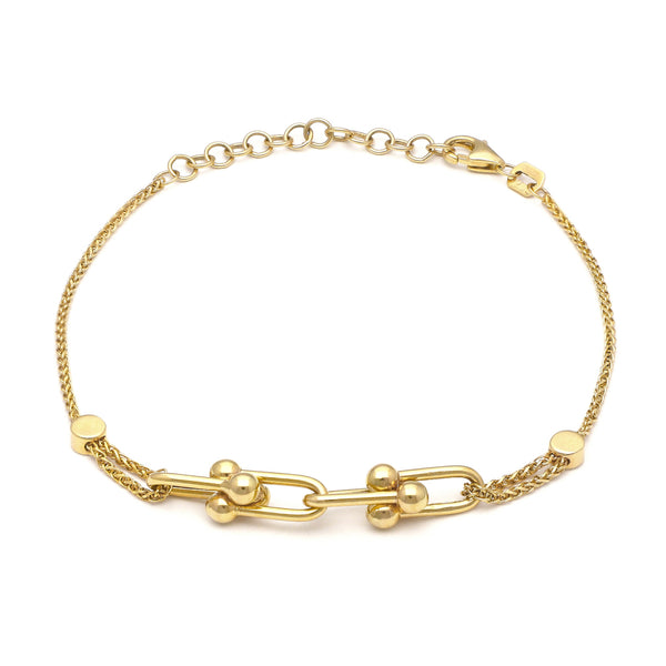 Pulsera eslabón tejido con aplicaciones en oro amarillo 14 kilates.