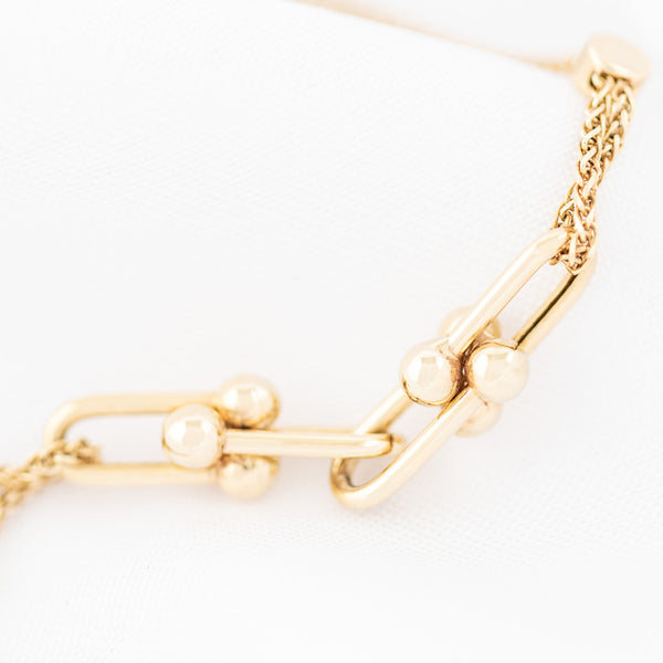 Pulsera eslabón tejido con aplicaciones en oro amarillo 14 kilates.