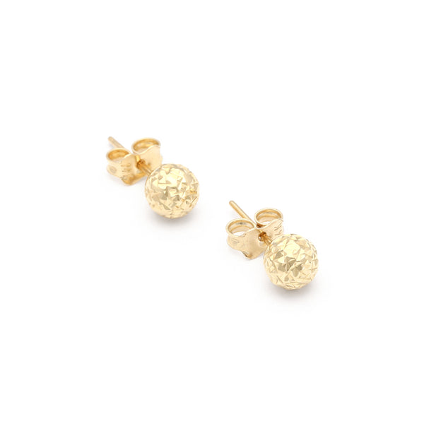 Aretes facetados en oro amarillo 14 kilates.
