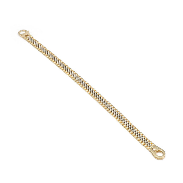 Pulsera eslabón articulado con aplicación motivo corona en oro dos tonos 14 kilates.