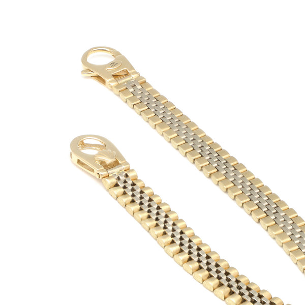 Pulsera eslabón articulado con aplicación motivo corona en oro dos tonos 14 kilates.