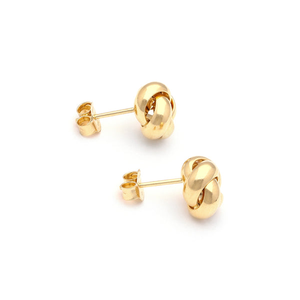 Aretes diseño especial motivo nudo en oro amarillo 14 kilates.