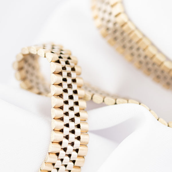 Pulsera eslabón articulado en oro dos tonos 14 kilates.