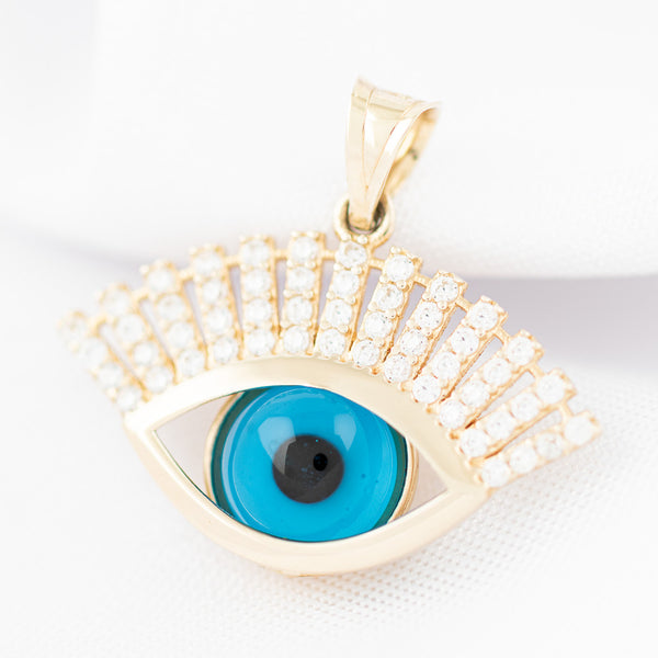 Dije diseño especial motivo ojo con circonias y sintético en oro amarillo 14 kilates.