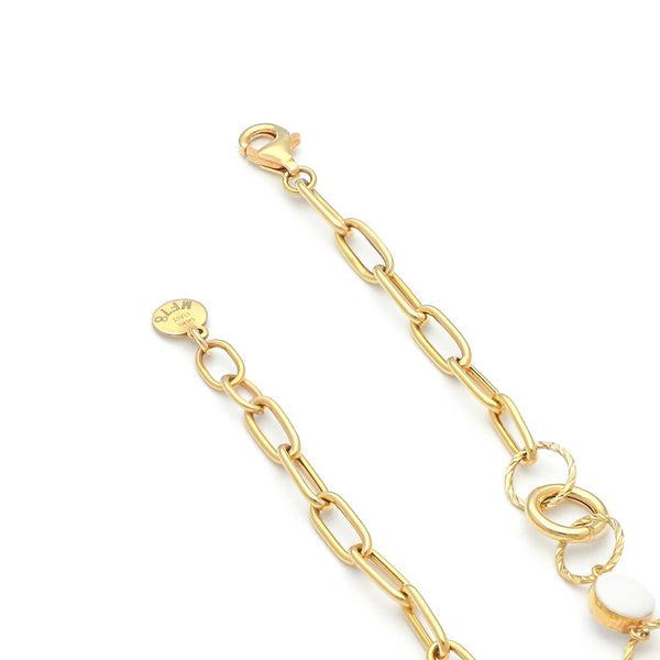 Pulsera eslabón cruzado con aplicaciones y sintéticos en oro amarillo 14 kilates.