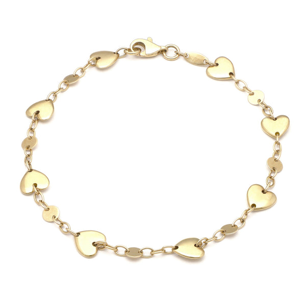 Pulsera eslabón cruzado con aplicaciones motivo corazón en oro amarillo 14 kilates.